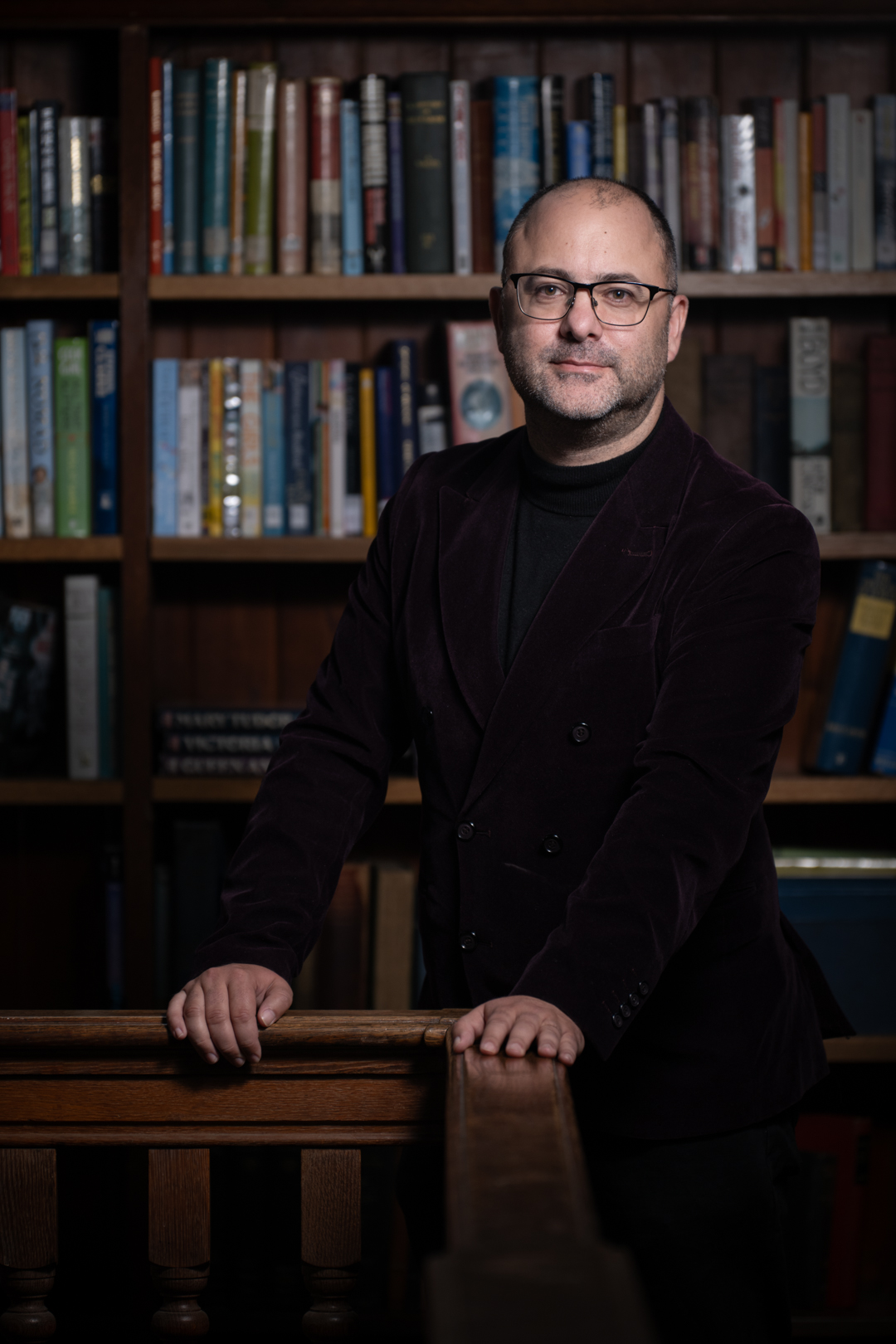 Nigel standing in front of books
